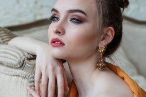 Woman wearing gold earrings image