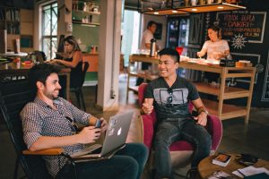 Image of two guys chatting over laptop Small Business Marketing & Mindset Tips